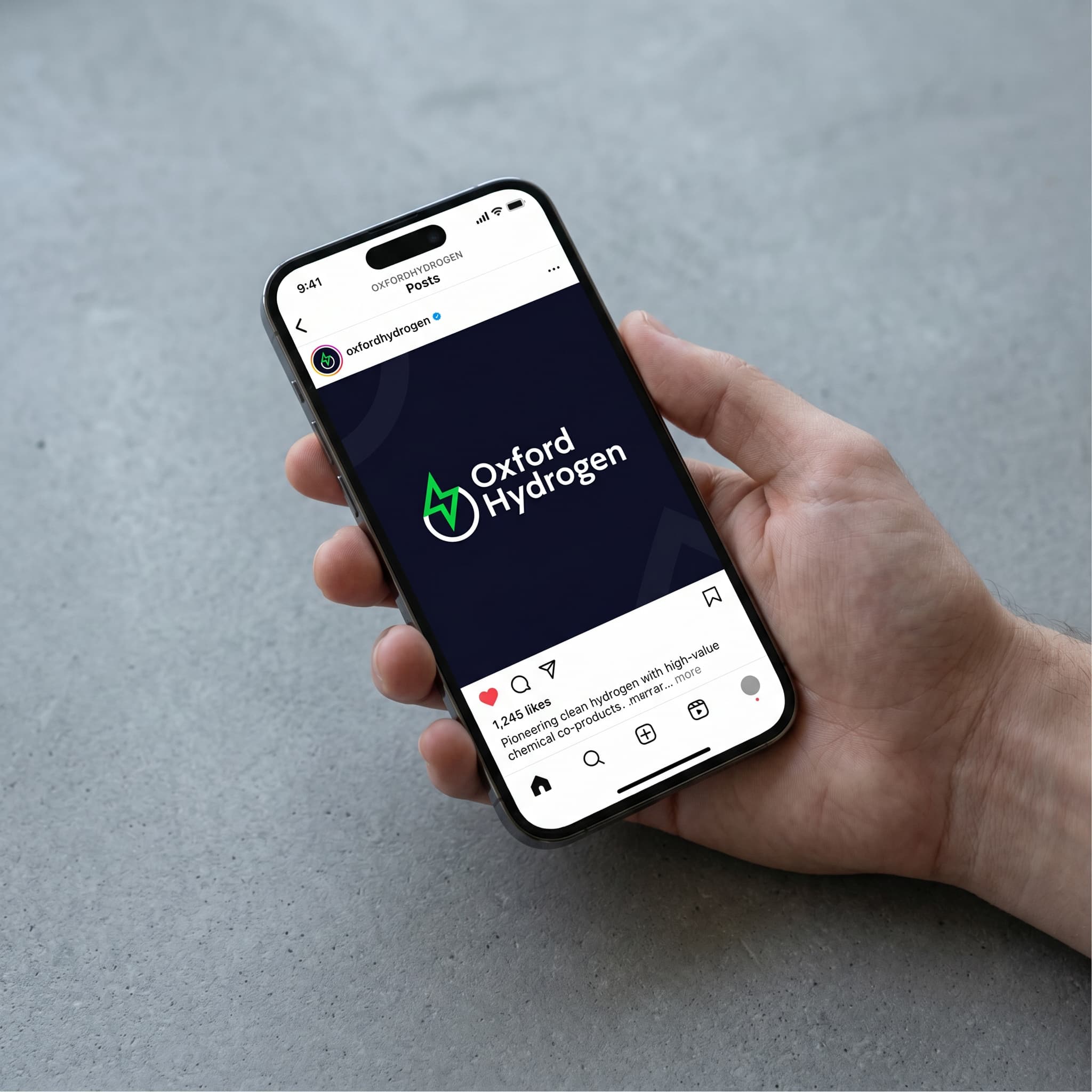 Hand holding a phone displaying a mock up of how the new logo looks on a social media post